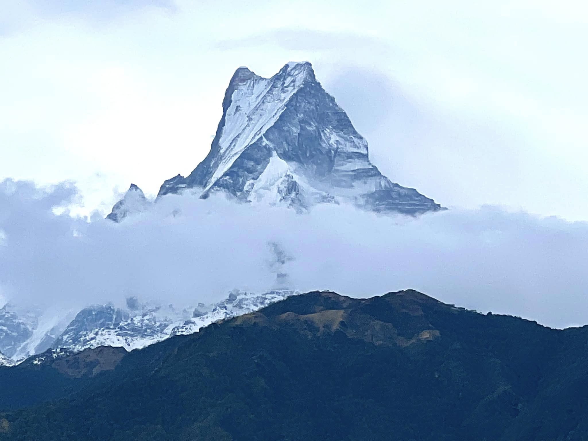 Machhapuchhre (Fishtail) peak rising above the clouds, seen from Ghandruk
